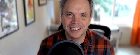 Chris Albrecht smiling while speaking into a microphone